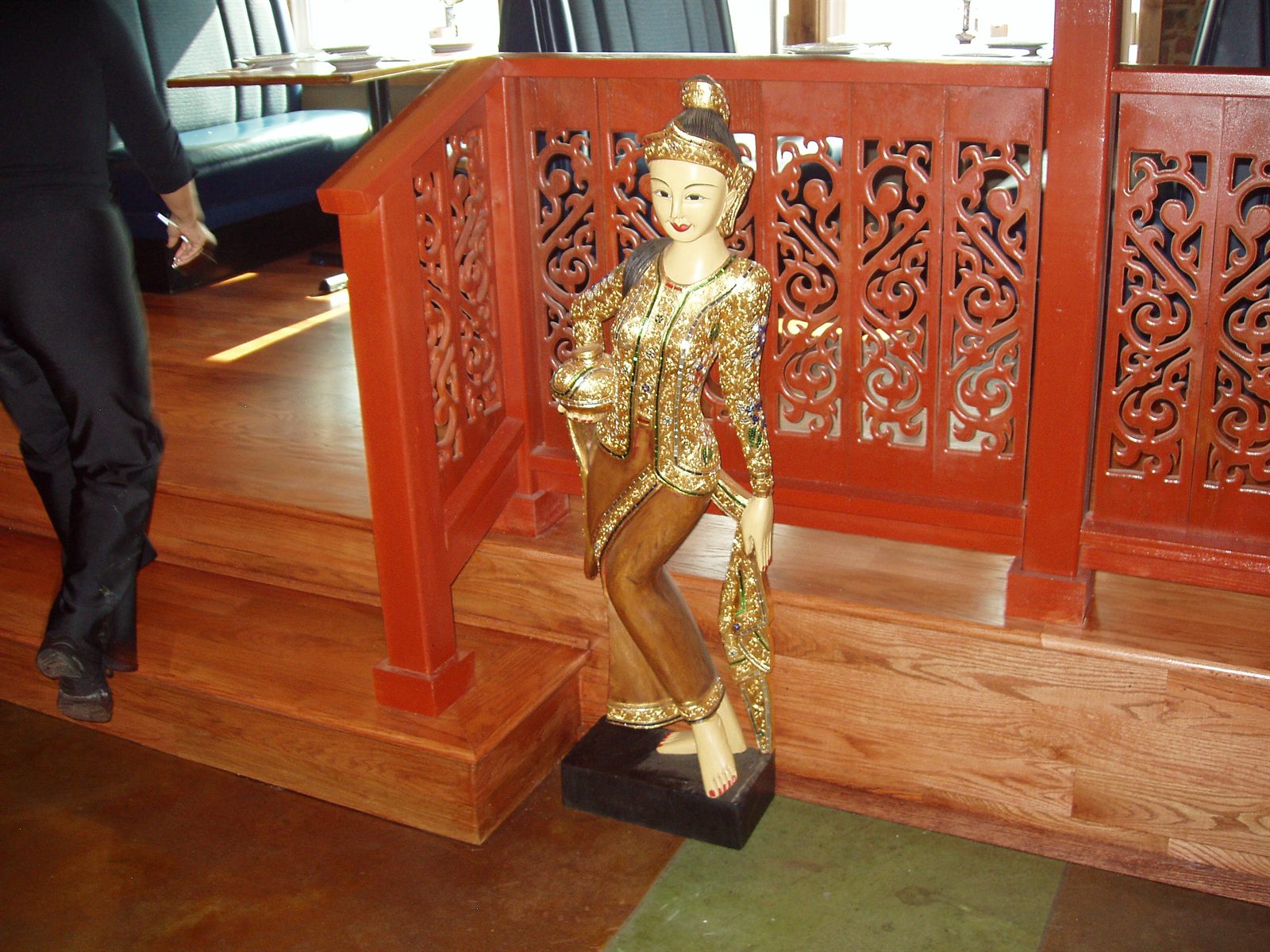 Carved red railing and gilded statue